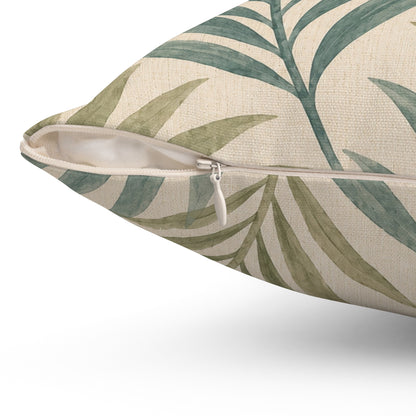 Decorative pillow with green leaf pattern on a beige background
