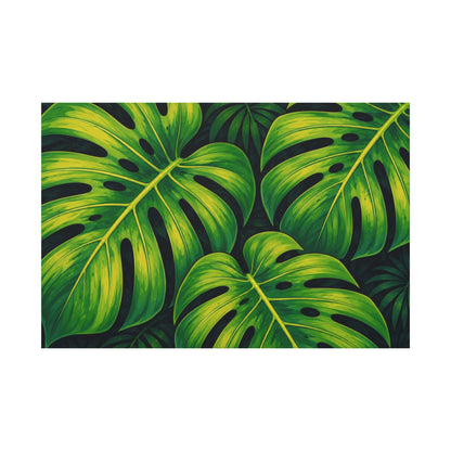 A rectangular art print featuring a vibrant tropical pattern of green monstera leaves on a dark background, displayed against a solid white backdrop.