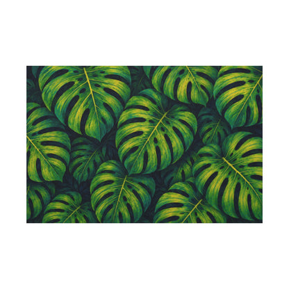 A rectangular canvas print featuring a dense pattern of overlapping green monstera leaves with yellow highlights, shown against a plain white background.