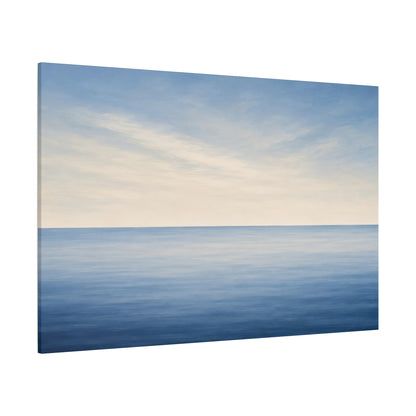 A rectangular canvas wall art print showing a calm ocean horizon under a pale blue and cream sky, photographed against a plain white background.