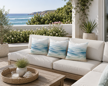 Outdoor seating area with a white sofa, decorative pillows, and a view of the ocean.