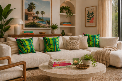 Living room with a beige sofa, green leaf-patterned pillows, and a coffee table with decorative items.
