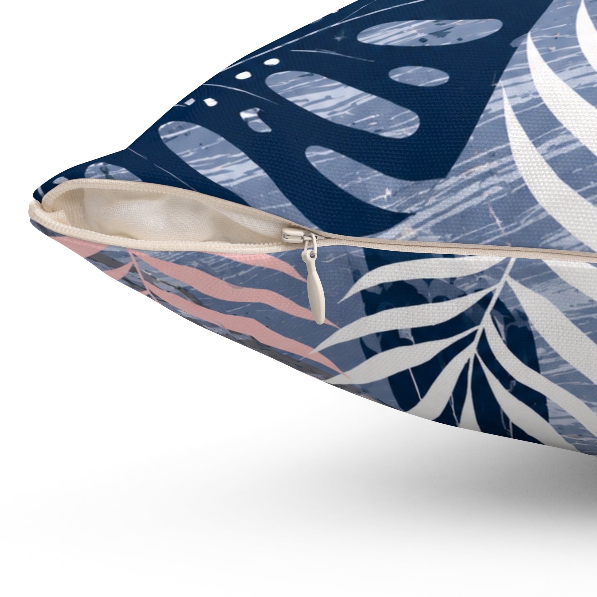 Pillow with tropical leaf pattern on a blue background
